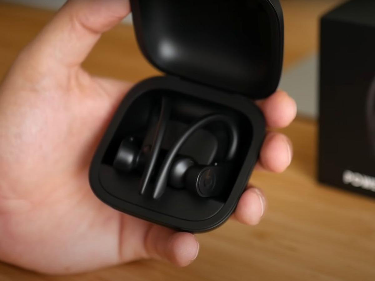 Powerbeats earbuds inside the case with the case lid open. (From: Youtube/Omar Correa)