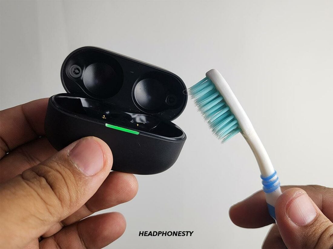 Using a toothbrush to remove any stubborn dirt from the case's interior and exterior.