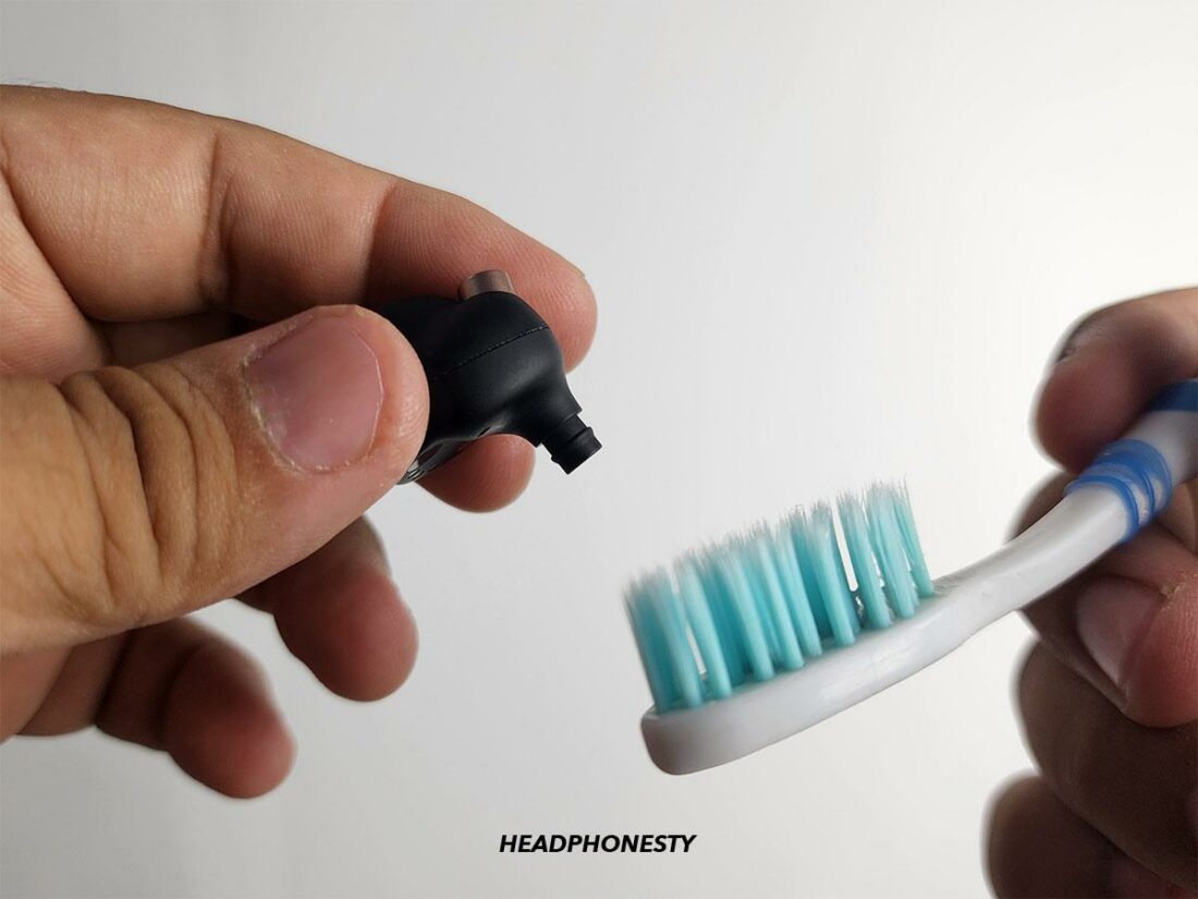Use a toothbrush to clean the speaker mesh.