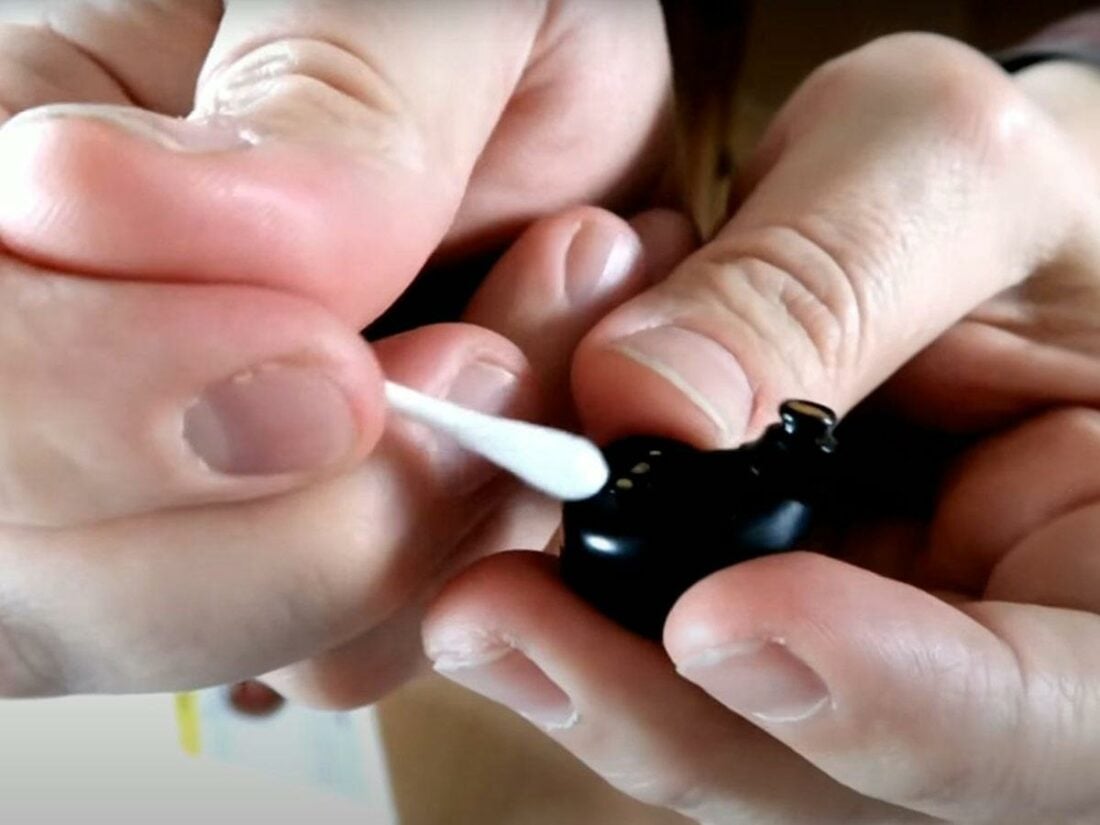 Use a cotton swab soaked in alchohol to clean the earbuds shell. (From: Youtube/Griffin Benchmark)