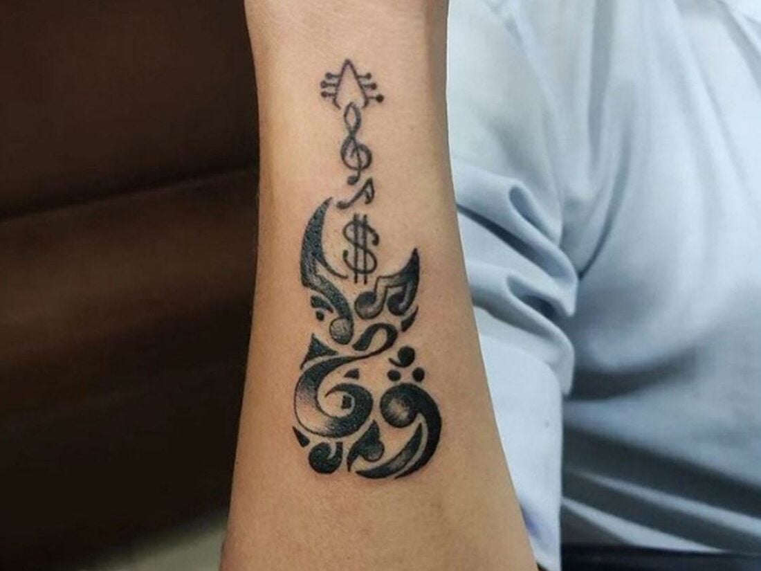 Music symbols forming a guitar. (From: Instagram/Tattoo the Art Studio)