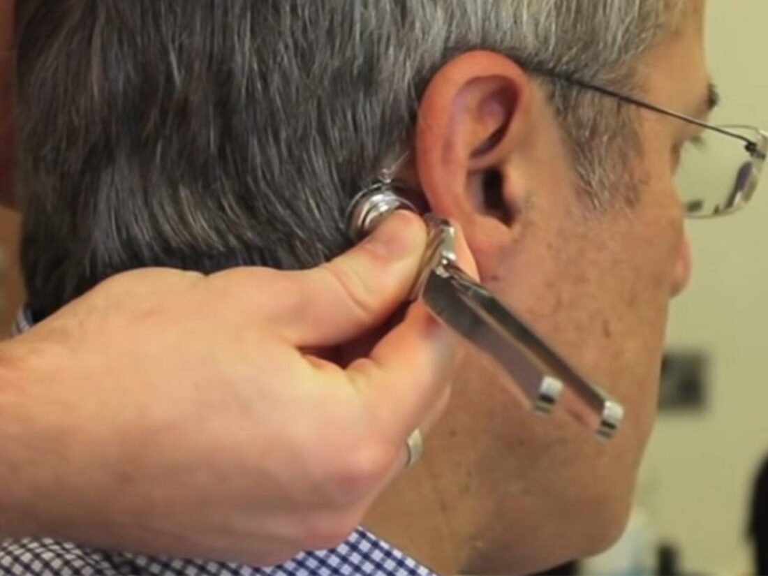 Tuning fork is placed in the bone behind patient's ear. (From: YouTube/Doctor O'Donovan)