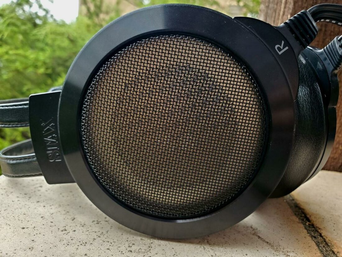 You can see that the stator, the metal plate behind the grill, is not perforated on the outside. This is unusual for electrostatic headphones.