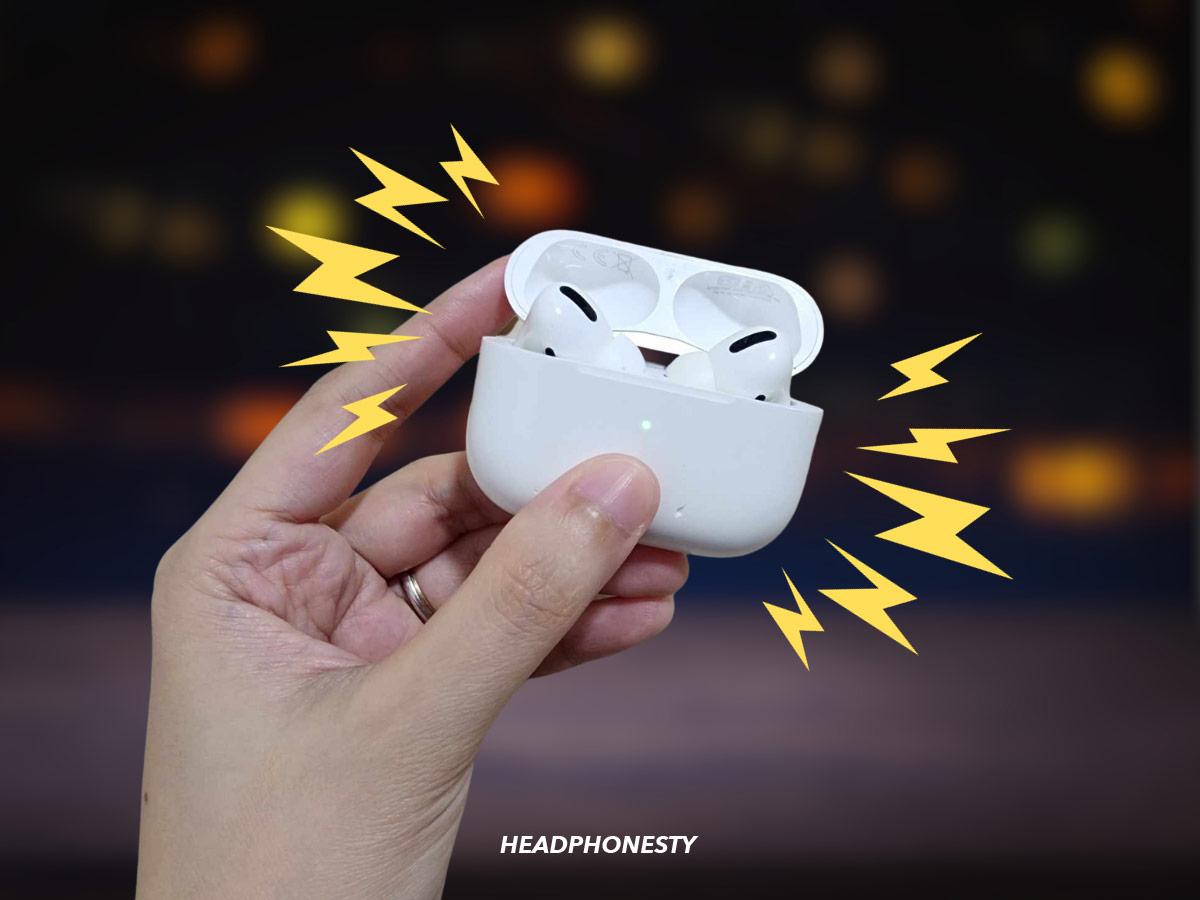 Holding AirPods and showing the pairing light