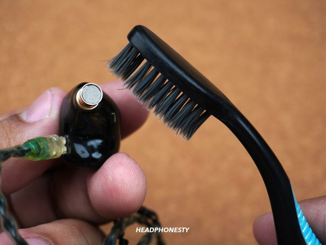 Use a toothbrush to clean the earbuds’ speaker and mesh.