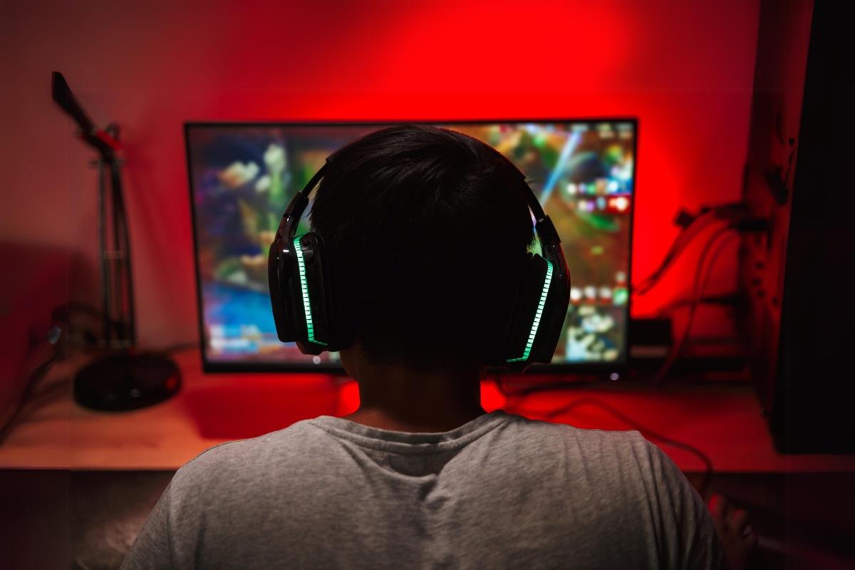 Gamer wearing headphones while playing League of Legends