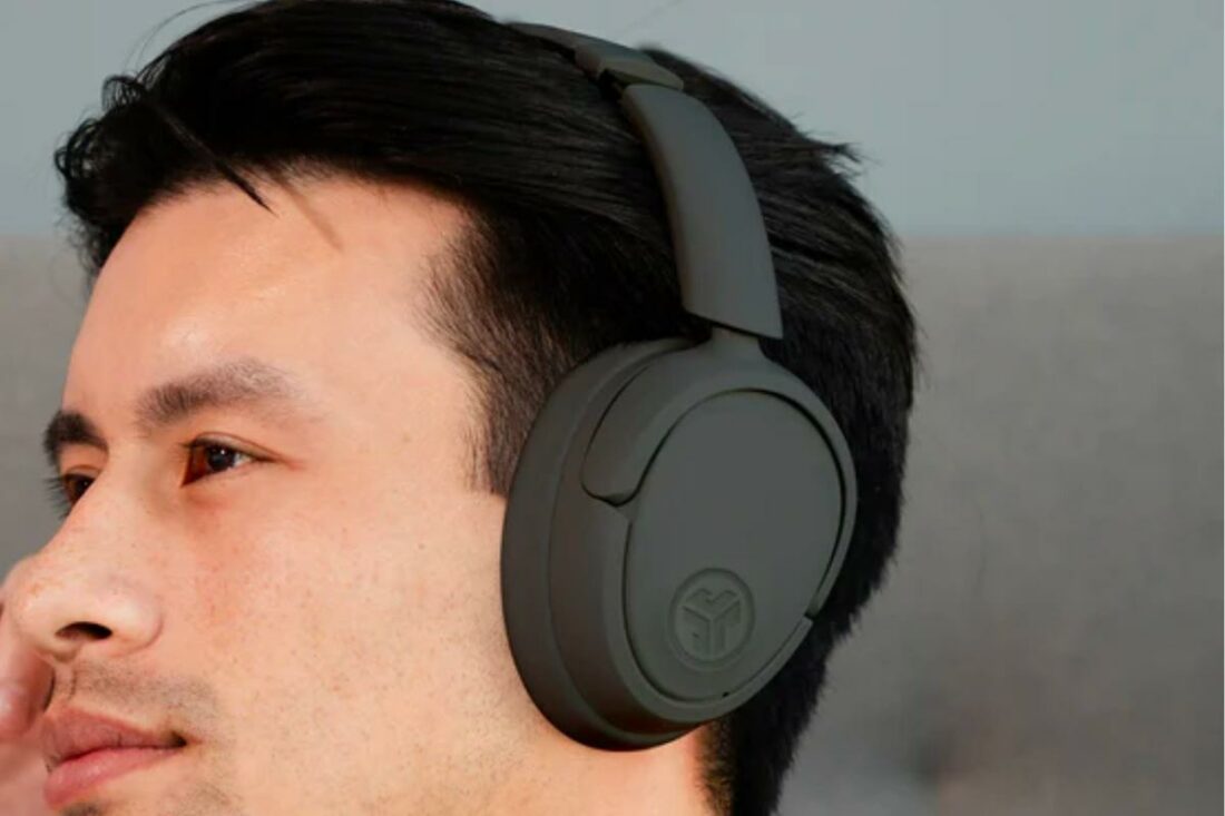 Man wearing the JBuds Lux Headphones. (From: JLab)