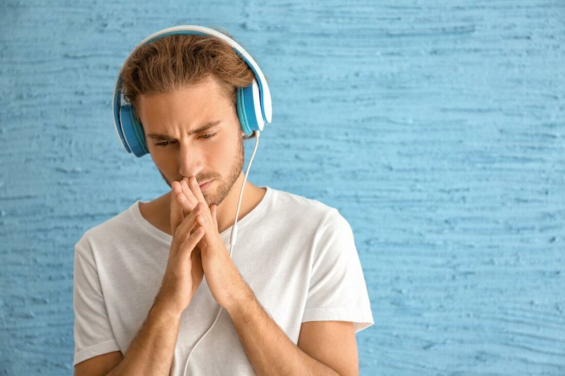 Man seriously listening to a sad song.