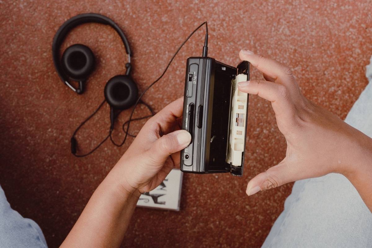 A cassette being loaded into a Walkman.